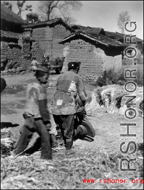 A close-up of rice threshing from the first village on the way to Yangkai. During WWII.