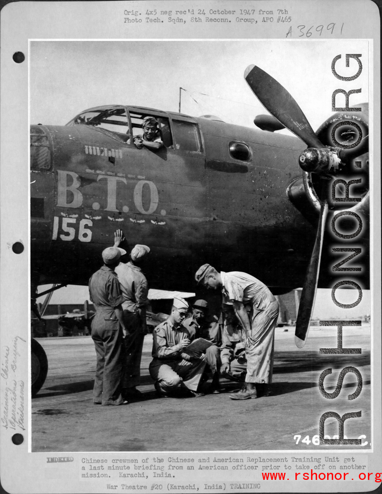 Chinese crewmen of the Chinese and American Replacement Training Unit get a last minute briefing from an American officer prior to take off on another mission. Karachi, India. Standing before the B-25 "B. T. O."  Image courtesy of Tony Strotman.