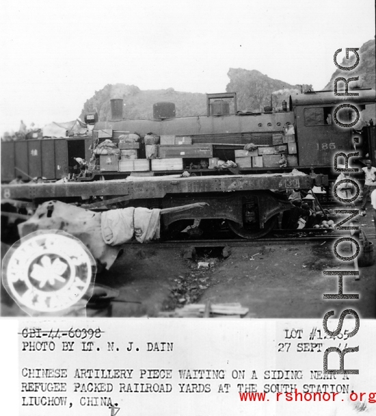 September 27, 1944  During WWII, Chinese artillery piece waiting on a siding near a refugee packed railroad yard at the south station, Liuchow, China.  Photo by Lt. N. J. Dain