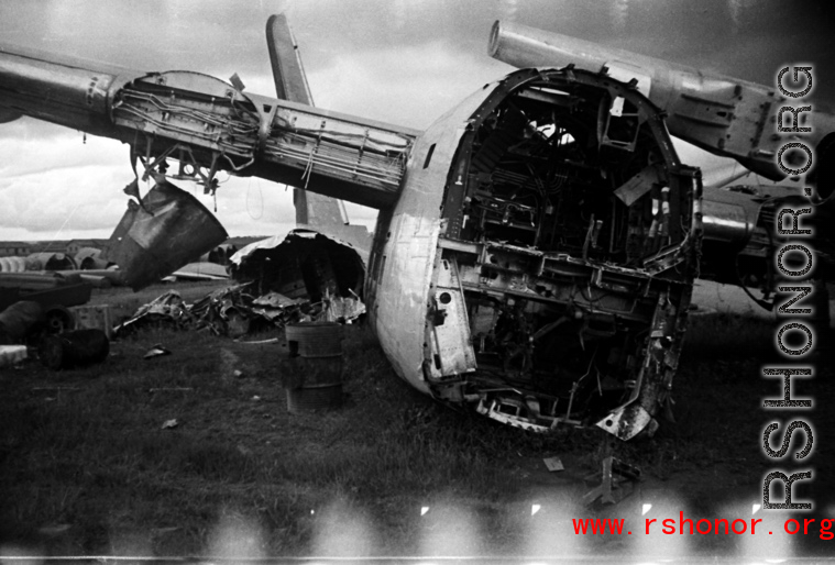 An image from the Roubinek Collection, showing a wrecked and broken-backed B-24 bomber in a boneyard near the base. in Yunnan province, China, most likely around the Luliang air base area.