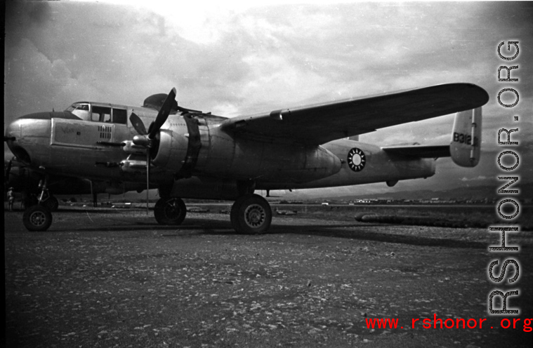 A B-25 with Nationalist markings, tail number #B31205, with bombs laid out ready for loading, at the American air base at Luliang in WWII in Yunnan province, China.