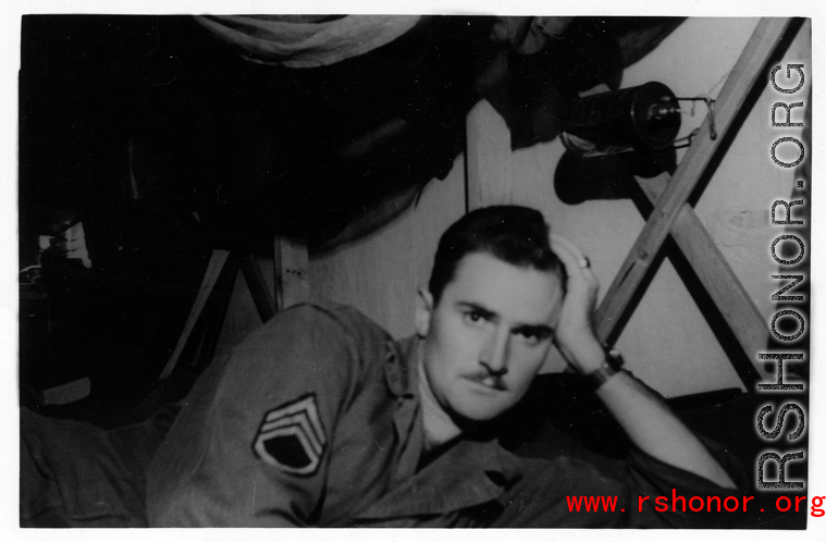 The collector posing on his bunk in the barracks. Likely in Yunnan province. During WWII.