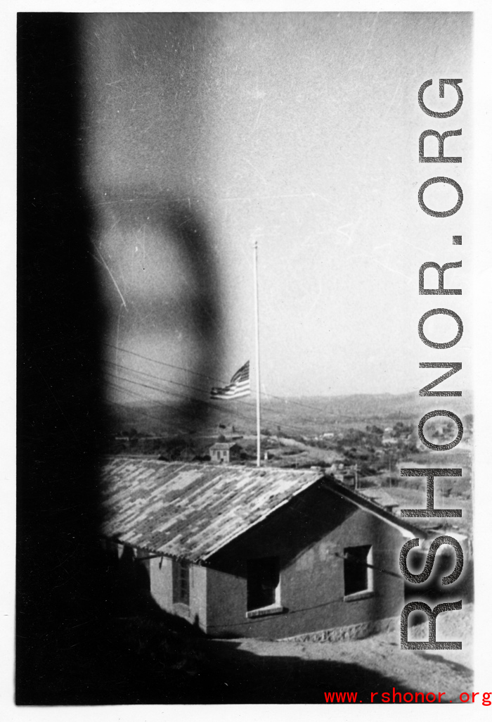 An American flag at half-mast in the barracks area at an American base in Yunnan, China, during WWII.