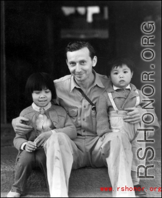 Eugene Wozniak, a combat photographer who served in the CBI, as part of the 491st Bomb Squadron, with two Chinese children during WWII.