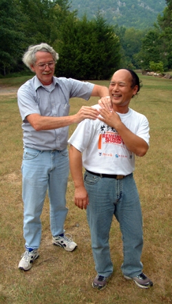 Tony Strotman giving a shoulder massage to HUANG Xiling, the Remembering Shared Honor cameraman.