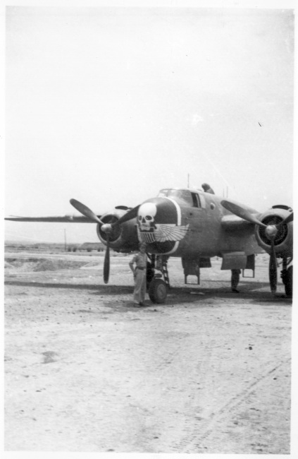 An oversized "Skull & Wings" insignia on plane's side near the nose indicates this parked B-25J Mitchell is assigned to 490th Bomb Squadron, 341st Bomb Group.  The 490th had stayed in India, attached to Tenth Air Force, when 341st BG moved from to China in January 1944. With aerial combat finished in Burma, the 490th BS (attached to 312 Fighter Wing) moved in late April 1945 to Hanzhong (Han-chung), southwestern Shaanxi Province, central China.  (Additional information courtesy of Tony Strotman.)