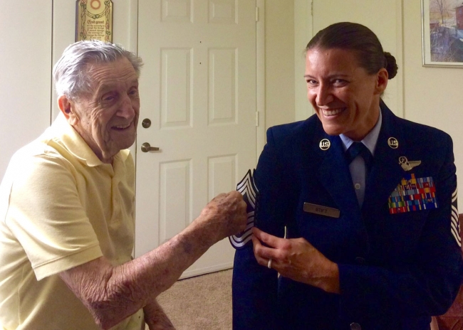 U.S. Air Force Lt. Col. (retired) Joseph S. Pesek, tacks chief master sergeant stripes onto his grandaughter Chief Master Sgt. Amanda J. Stift in 2015. Stift is the 403rd Wing command.