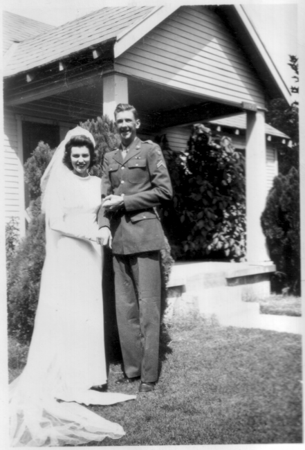 Newlywed standing before their residence, stateside, September 3, 1943.