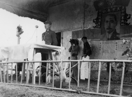 Chinese Lt. General Du Yuming, Nationalist 5th Corps (第五集团军总司令兼昆明防守司令杜聿明), makes speech during rally, while an American cameraman shoots movie film at the back.