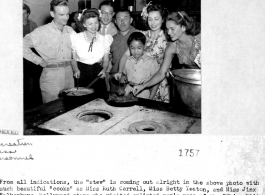 Cooks Ruth Carrell, Betty Yeaton, Jinx Falkenburg visit the enlisted men's mess of the "China Blitzer" fighter squadron and the "Flying Horse" fighter group. The cooks are (left to right): Sgt. Joseph Chirko,  Ruth Carrell, S/Sgt. Steve Nagy, Betty Yeaton, Jinx Falkenburg. In front is "Collen", Burmese refugee and mess attendant, in the background with glasses is Mr. John Woo, Hostel Manager.