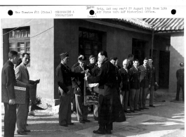 Major General Claire L. Chennault accepts the Victory Banner of the All China Troops Comforting Association from Bishop Paul Yu Pin, as Chinese delegates and members of the staff of the 14th Air Force look on. March 24, 1945