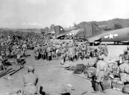 Chinese troops in Burma await transport on C-47 to China. Note the row of C-47 transport planes waiting. December 10, 1944.