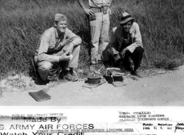 Lt. Colonel Wright Hiatt, Winchester, Indiana, and Capt. Berwyn Fry, 7314 Bennett Ave., Chicago, Ill., Engineers with the 14Th Air Force, and a Chinese worker, with two of the Japanese mines removed from the air strip, at Liuzhou (Liuchow), China.