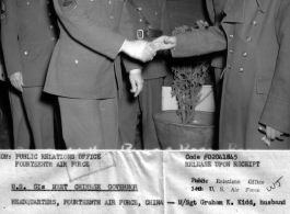 Graham K. Kidd was one of four enlisted men of Headquarters of the 14th Air Force chosen to attend Burma Road opening celebration dinner, and shaking hands with General Lung Yun. The American soldier behind them is M/Sgt. Richard L. Hapgood.