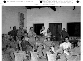 Americans and Chinese enjoy a bit of recreation in "Flanagan's Bar," named for Sgt. Wm. Flanagan, seated third from the left in front row. Lt. Tong, K. T, communications officer for the Chinese Air Force, plays the Chinese violin (二胡).  Image courtesy of Tony Strotman.