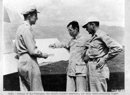 Capt. Joseph Norton, chief CACW Weather Officer, and Sgt. Jack Barishman discuss the approach of a "front" with Chinese Weather Officier, Capt. Y. H. Wei.