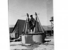 Poor man, and pumping from well at Hostel #3. China. 1944.