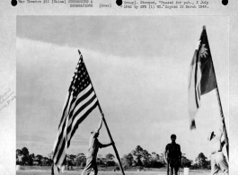 Flag raising ceremony at Nanning Air Base, China, on 8 July 1945, after its re-occupation by the Allies. Sgt. Edward F. Rossler hoists American flag, while a Chinese interpreter raises Chinese Nationalist flag.