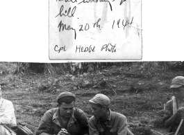 T/Sgt. Syd Greenberg, Combat Photographer, interacts with a Chinese soldier on the trail towards the Salween River. "7th day out and still walking up hill."  May 20, 1944.  Photo by Cpl. Hedge.