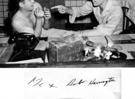 George M. Zdanoff (right) points a finger at Bob Harrington (left) at the photo lab at Hastings Mills, India, HQ during WWII.