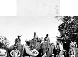 GIs pose with Kachin fighters (some riding elephants) in Burma during WWII.