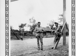 GI Carroll Cummings, 80th Fighter Group, pauses for a moment with a Chinese soldier (pockets full of grenades) on the Stilwell Road/Ledo Road, during WWII.