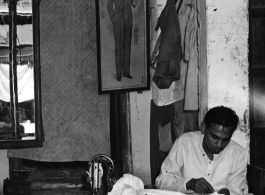 A clothing tailor working diligently in India during WWII.  Photo from Samuel J. Louff.
