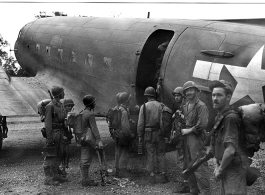 Tired Merrill's Marauders queuing up to board a C-47 transport plane, probably at Myitkyina, Burma. During WWII.