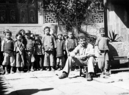 School kids in the school courtyard, with Fred Nash, 10 miles east of Yangkai, Spring of 1945.  From the collection of Frank Bates.