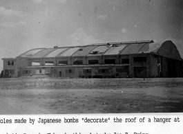 A hanger with holes from Japanese bombs in Xi'an (Hsian) Air Base during WWII.   Photo from Joe E. Ewing.