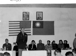Colonel Tex Hill addresses a crowd on June 29th, 1944, while Madam Chiang Kai-shek looks on.