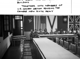 Surrender conference site in Zhijiang towards the end of war. Seated are members of Chinese army public info group who decorated the building, together with members of the U.S. combat section advising the Chinese New Sixth Army.
