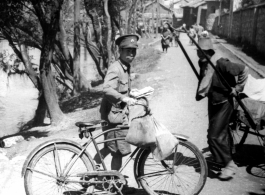 A Chinese postman delivers wartime mail by bicycle, during WWII.  Photo from Jesse D. Newman.