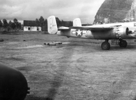 An 11th Bomb Squadron B-25J, #43-4387, in the preparation area at either Liuzhou or Guilin base, Guangxi province, China, in the fall of 1944. Photo was taken from the right side gunner position of another B-25. The propellers of '4387' are turning, so both aircraft are either returning from a mission or preparing to go on one.