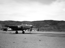 B-25 tail number 435 above a runway in Yunnan, likely Yangkai.  From the collection of Wozniak, combat photographer for the 491st Bomb Squadron, in the CBI.
