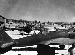 A captured Japanese A6M2 "Zeke", re-painted in Chinese Air Force (CAF) colors, with Chinese serial 'P5016'.  The aircraft directly behind the 'Zeke' is a P-43 "Lancer" flown by the CAF.  The aircraft are probably at Kunming--because of  the 23 Fighter Group P-40 in the background on the right.  (information provided by Tony Strotman)