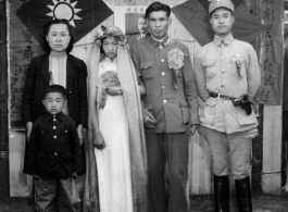 A wartime wedding in Yunnan province, China, with a very young and unenthusiastic bride.  See alternative image here.