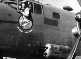 First Lt. Richard P. Kendall, pilot, leans out window of a 491st Bomb Squadron's B-25D aircraft in a revetment at Yang Chiseh Airfield, Yangkai, Yunnan Province, China. This plane has been modified with the twin .50 caliber machine gun side packs on lower fuselage side. Another would be on the opposite, starboard, side of the plane.