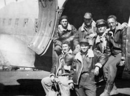 GIs lounge at the loading door of a C-47 transport plane in China during WWII during evacuation because of Ichigo: "We Were Forced To Evacuate Our Base At Kwelin, China And This Is A Pic Of Some Of The 396th Guys Loading On A C-47 To Get Out Of There. Standing: Weidenbrenner, and Reese. L/R In Plane: Souder, O'Connor, Rodriguez, and Wolfe."
