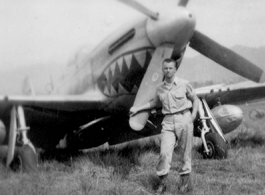 Elmer Bukey poses for a photo in front of a P-51 at Liangshan, China, during WWII.