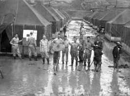 GIs and Chinese workers digging to drain the water away at a tent city of flooded living quarters at Liangshan. "This Is A Shot Of Our Gracious Living Quarters At Liangshan, China After The Creek Next To The Place Overflowed And Flooded Us Out." During WWII.
