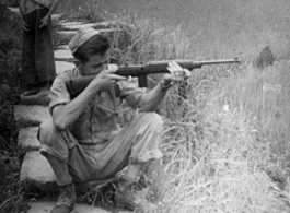 "Ralph O'Connor Taking Dead Aim At His Target While A Chinese Boy Looks On Hoping To Maybe Get Whatever He May Shoot."