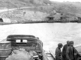 12th Air Service Group convoy crossing river by barge in China during WWII.