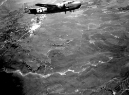 Smoke rises on the ground, behind B-25 #437 after an attack by American B-25s in either SW China, Indochina, or the Burma area.  This might be fairly close to Tengchong in China.
