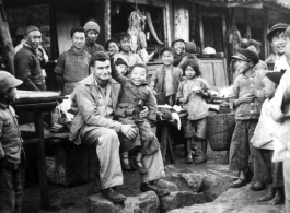 At the hardware stand, GI Fred Nash, with appreciative local people. Yangkai Village, Spring 1945.