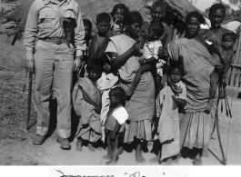 A GI with local people in India during WWII.    From the collection of David Firman, 61st Air Service Group.