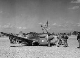 A P-40, tail #264, down on its belly in Guilin, likely a 26th Fighter Squadron "China Blitzers" P-40K. Emblem painted on cowling prior to the application of a sharkmouth."    (Thanks for additional info from jbarbaud.)  From the collection of Hal Geer.
