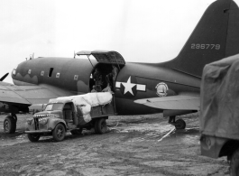 A C-46 cargo plane of the Air Transport Command (ATC), tail number #296779, being unloaded (or loaded) in China during WWII.