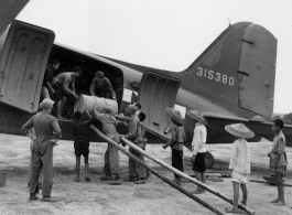 Unloading (or loading) fuel barrels from C-47 transport plane #315380 in China during WWII. Note how some of the Chinese laborers are just teenagers, and overshadowed by the much larger adult American soldiers.