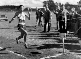 A runner crosses the finish line at a track meet in China during WWII, on October 23, 1944.